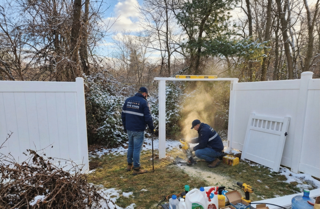 A secure tan vinyl privacy fence with double gates installed at a townhouse, demonstrating a clean boundary upgrade during an Emergency Fence Repair Maryland 2026 service call.