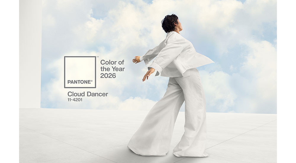 Infographic and visual representation for the PANTONE Color of the Year 2026, featuring "Cloud Dancer" (PANTONE 11-4201). This soft, creamy off-white is highlighted as a foundational, high-equity warm neutral color that is defining the 2026 trend for cozy, lived-in warm neutral kitchens, replacing starker, colder whites.